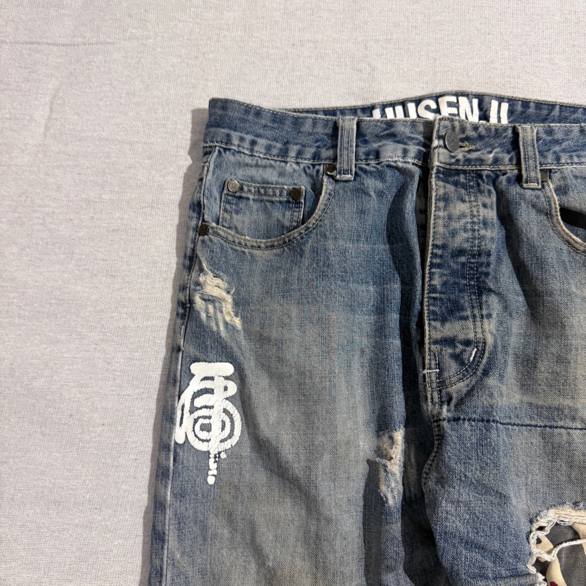 HUSENJI Distressed Denim Jeans With Kanji Print And Camo Patchwork — photo 7 of 10