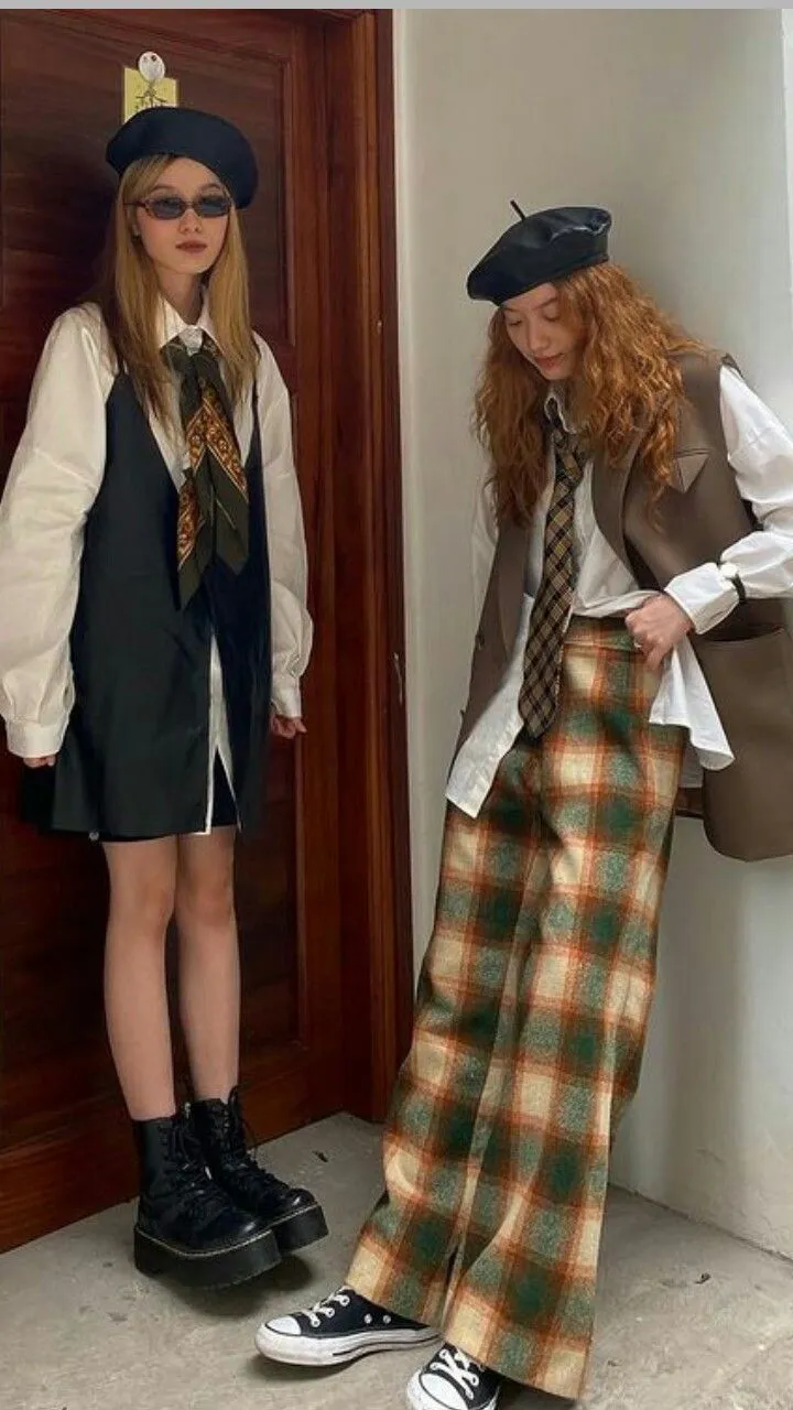 Art Academia aesthetic — The combination of plaid trousers, oversized white shirts, vests, and ties, along with the overall styling, strongly evokes the Art Academia aesthetic, particularly the painter-student vibe and academic staples.