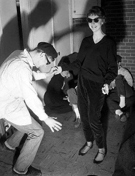 Beatnik aesthetic — This image perfectly captures the described Beatnik look with the black turtleneck, capri pants, ballet flats, and the woman's hairstyle and makeup, reminiscent of Audrey Hepburn in 'Funny Face'.