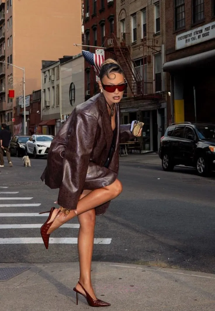 Boujee aesthetic — The head-to-toe designer look, bold sunglasses, and confident pose strongly embody the unapologetic luxury-flexing described in the Boujee aesthetic.