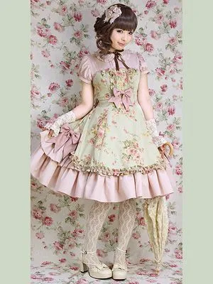 Classic Lolita aesthetic — This image strongly embodies Classic Lolita with its floral print, muted color palette, ruffles, bows, and the overall elegant, vintage-inspired silhouette, reminiscent of brands like Mary Magdalene.