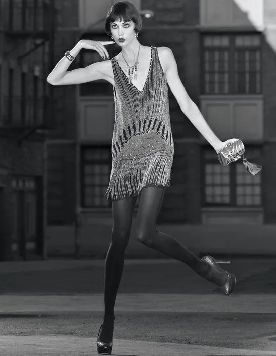 Flapper aesthetic — Drop-waist beaded shift dress, knee-length fringe, bobbed hair, and T-strap heels perfectly capture the Flapper aesthetic.