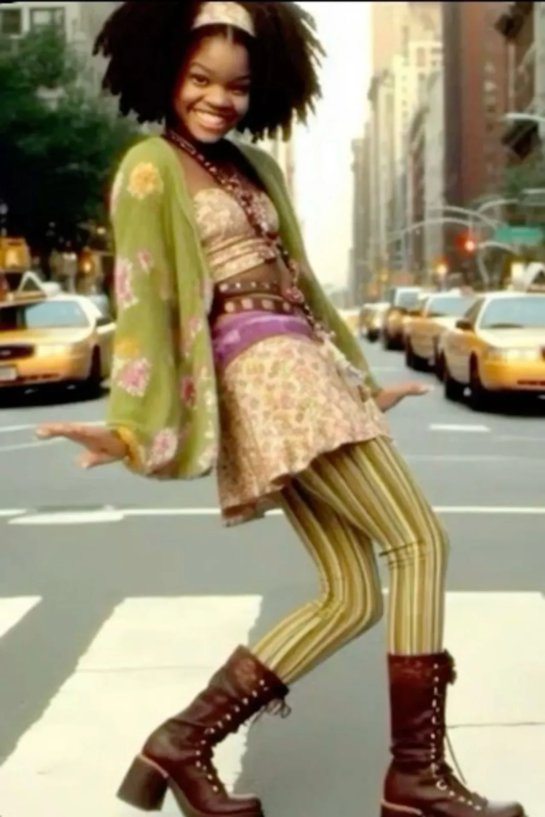 Funk aesthetic — The Afro hairstyle, patterned leggings, platform boots, and overall vibrant, expressive styling are a strong representation of the Funk aesthetic.