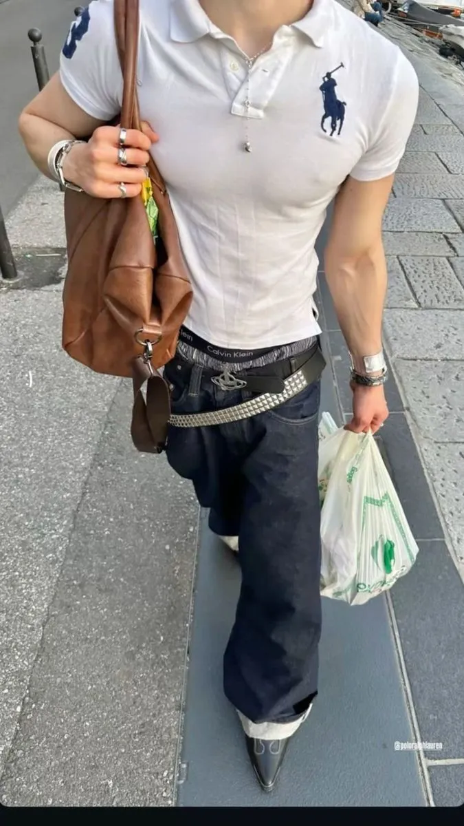 Guido aesthetic — The tight-fitting polo shirt, prominent designer logo belt, and baggy jeans are strong indicators of the Guido aesthetic, especially the emphasis on sculpted physique and designer brands.