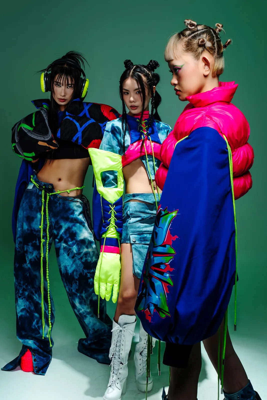Hyperpop aesthetic — The combination of neon accents, asymmetric haircuts, platform boots, mesh details, and saturated colour blocking perfectly captures the described visual signature and garments.