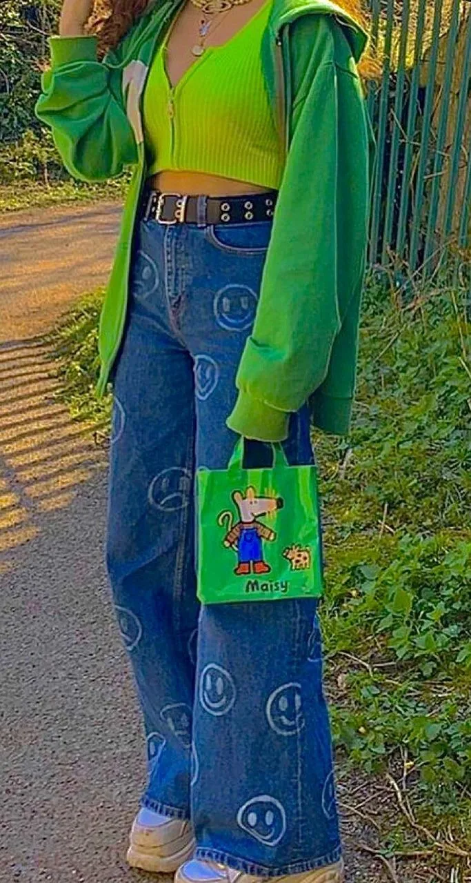 Indie Kid aesthetic — The smiley face patterned baggy jeans, lime green top, and bucket hat are all signature elements of the Indie Kid aesthetic.