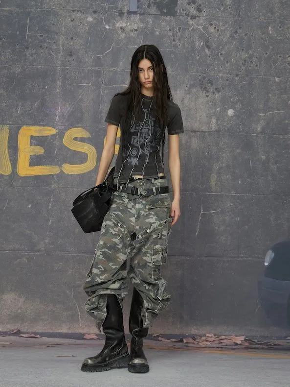 Industrial Goth aesthetic — The tactical kilts over cargos, chunky platform boots, and monochrome palette with a graphic tee are a direct match for signature garments and visual cues described.