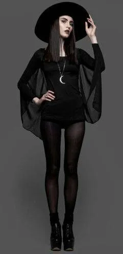Nu Goth aesthetic — This image perfectly captures the Nu Goth aesthetic with the wide-brim hat, black maxi dress, platform boots, and occult-inspired crescent moon necklace.