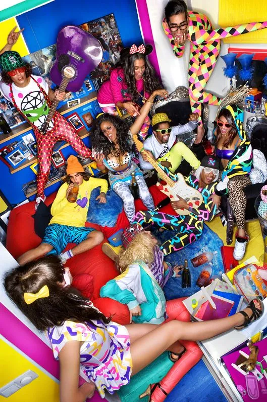 Nu Rave aesthetic — The image is a vibrant explosion of neon colors, cartoon graphics, and rave-inspired accessories like glow sticks and platform shoes, directly referencing the 'nu-rave' aesthetic's global shorthand.