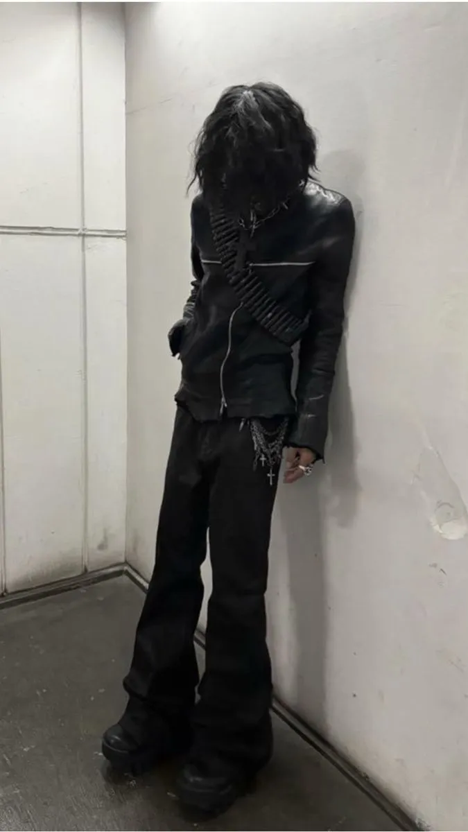 Opium aesthetic — The all-black palette, extreme proportions in the leather jacket and flared pants, brutalist footwear, and the overall dark, non-human silhouette are a perfect encapsulation of the Opium aesthetic.