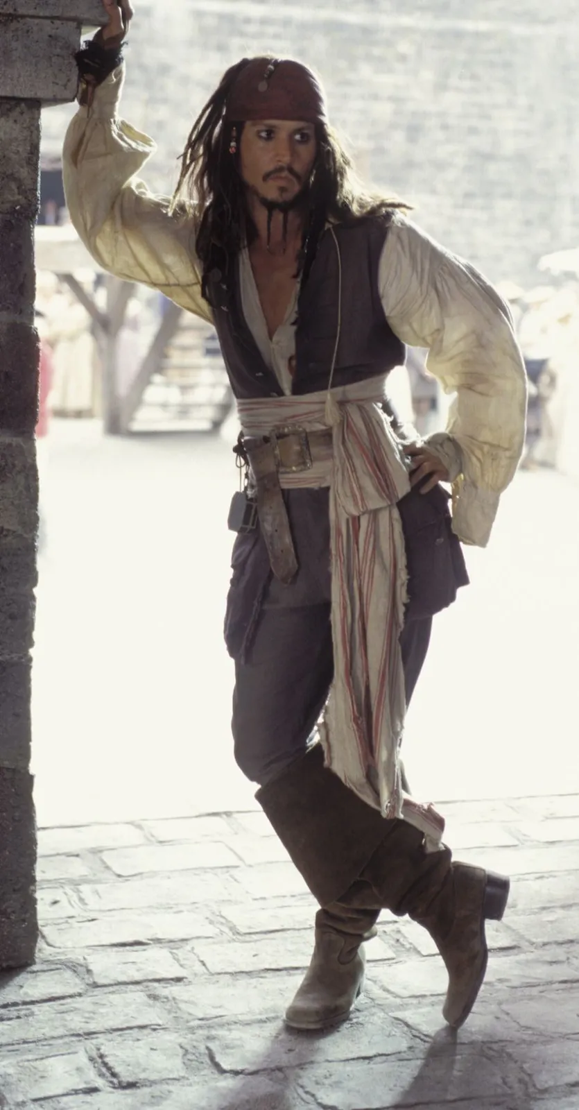 Pirate aesthetic — This is a definitive representation of the pirate aesthetic, directly referencing the 'Pirates of the Caribbean' cinematic style with its poet shirt, waistcoat, sash, and boots.