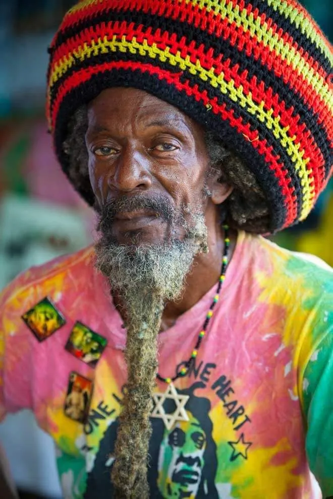 Reggae aesthetic — The Rasta tam, Bob Marley t-shirt, and the overall styling are a near-perfect representation of the described Reggae aesthetic.
