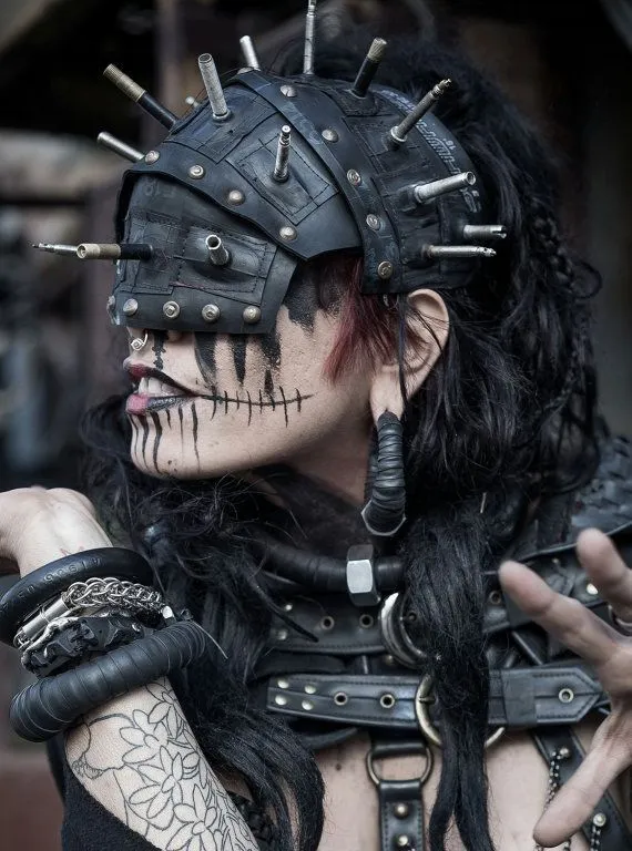 Rivethead aesthetic — The extreme use of rivets, leather, face paint, and industrial-inspired headwear is a perfect representation.