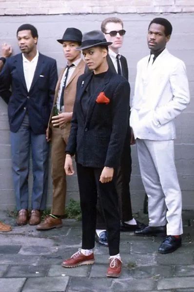 Rude Boy aesthetic — Sharp suits, pork pie hats, and polished shoes directly reference the Rude Boy uniform and its aspiration.