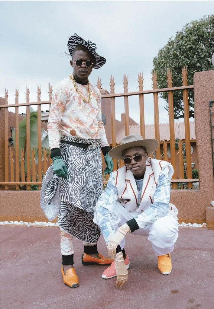 Skhothane aesthetic — The vivid color-coordinated suiting, prominent hats, bold patterns (zebra print), and the overall group presentation strongly evoke the Skhothane aesthetic.