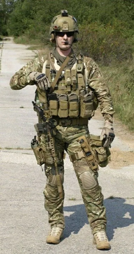 Tacticool aesthetic — This image exemplifies Tacticool with its full multicam gear, plate carrier, helmet, combat boots, and rifle, clearly fitting the description of modern special-forces gear.