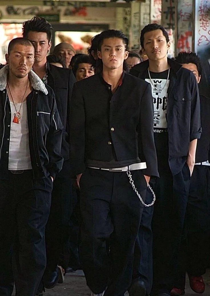 Yanki aesthetic — The group is dressed in modified school uniforms (gakuran style) and exudes a rebellious aura, directly matching the description of Yanki youth culture.